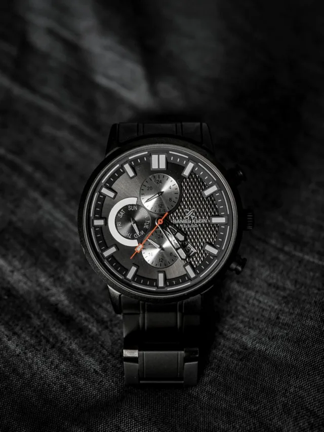Close-up of an elegant black wristwatch with detailed dial. Stylish fashion accessory.